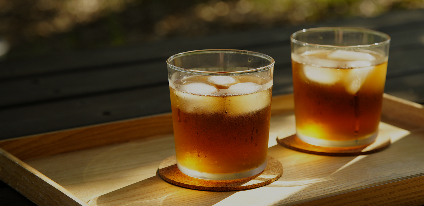 Refreshing iced Japanese tea for summer, served on a wooden tray