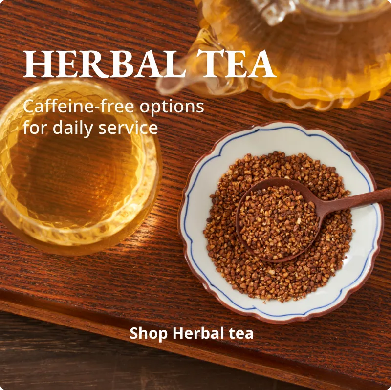 Herbal tea with a cup of tea and tea leaves on a wooden surface.